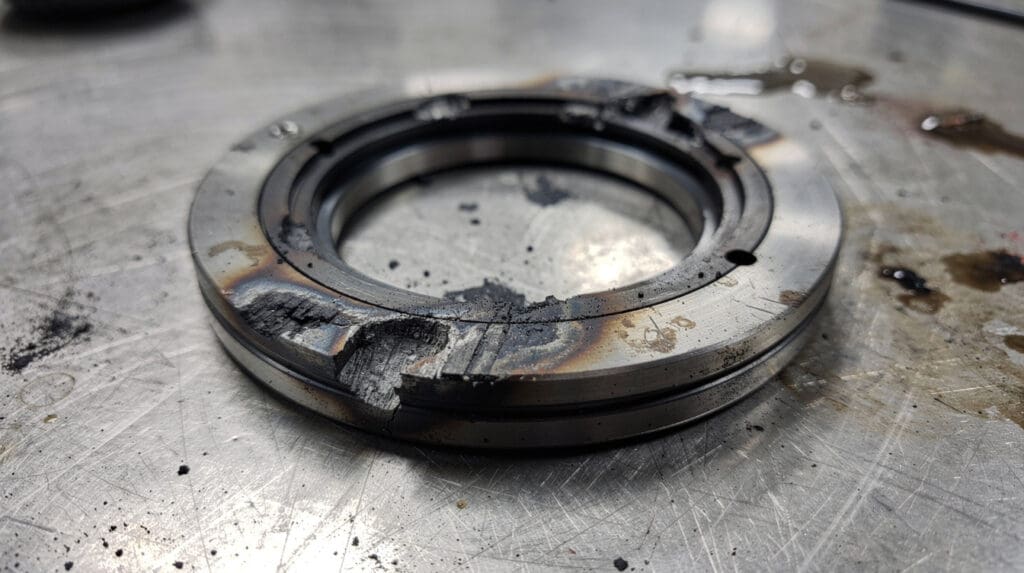 Damaged mechanical seal from a centrifugal pump showing severe scoring and dry-run damage